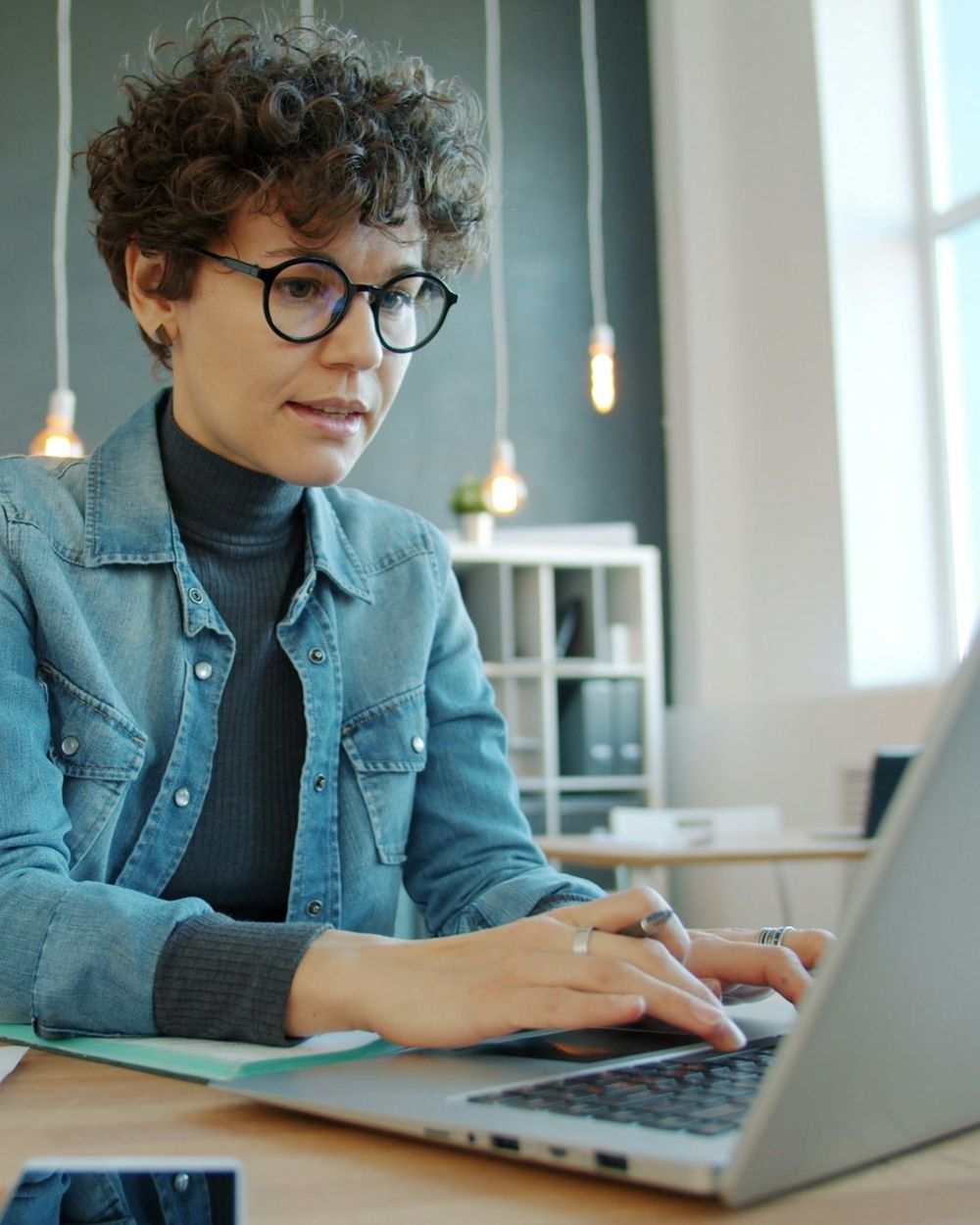 Business owner working on a laptop in a bright modern office